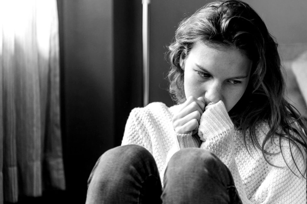 Jeune femme triste dans un coin